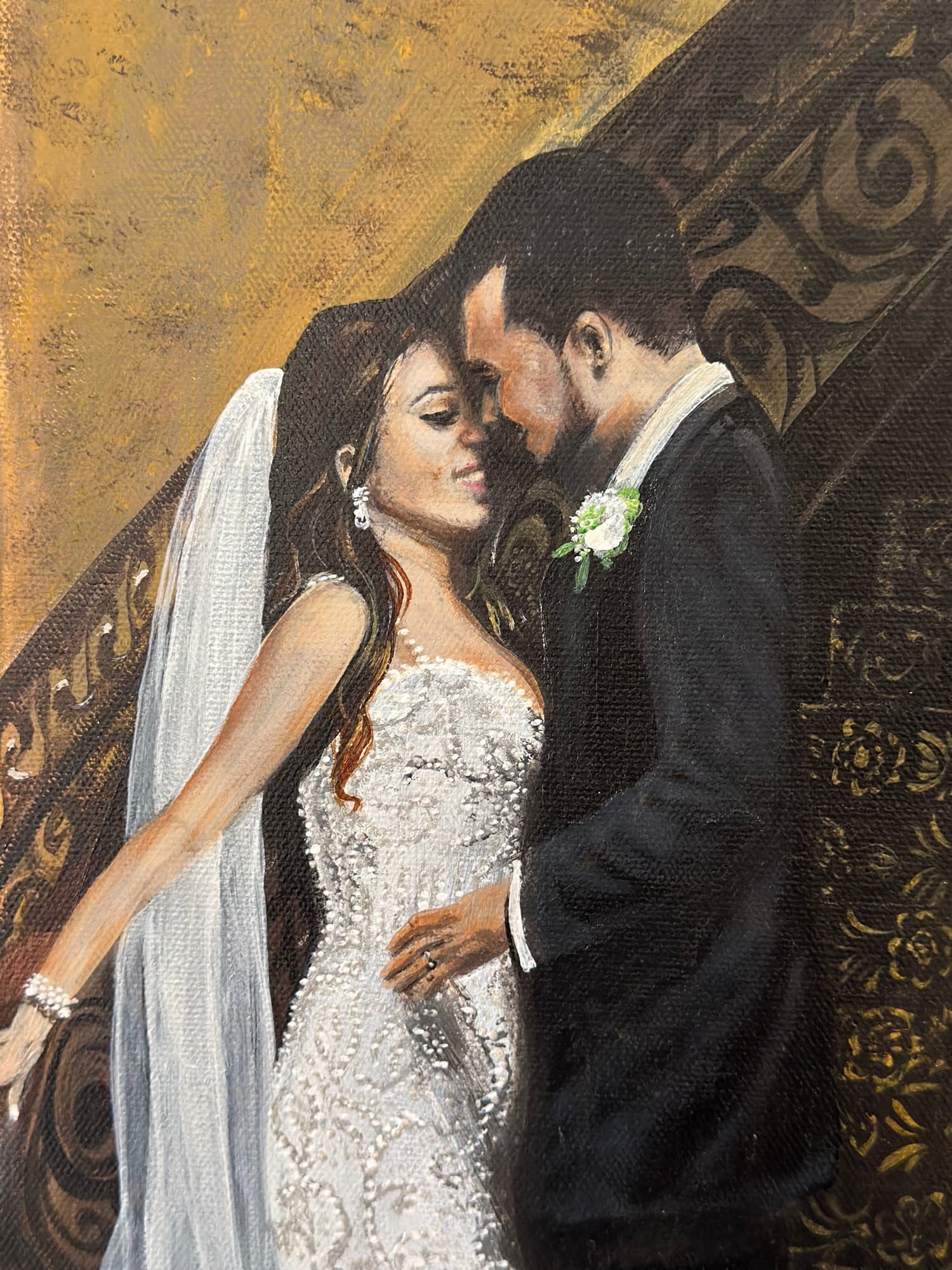 Detail of the bride and groom embracing — facial expressions and curve of the veil