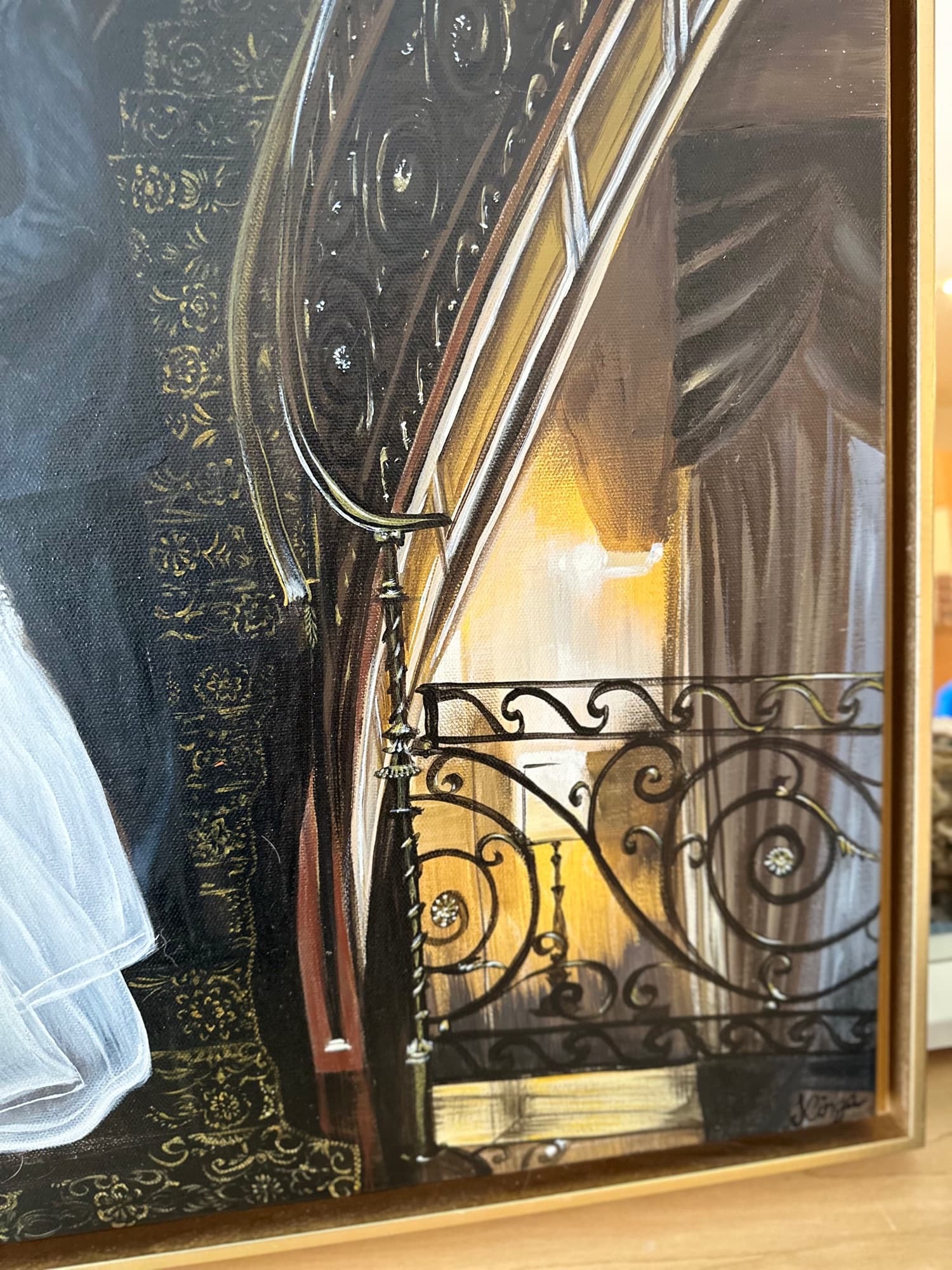 Lower stair detail — wrought-iron scrollwork against warm tungsten interior light