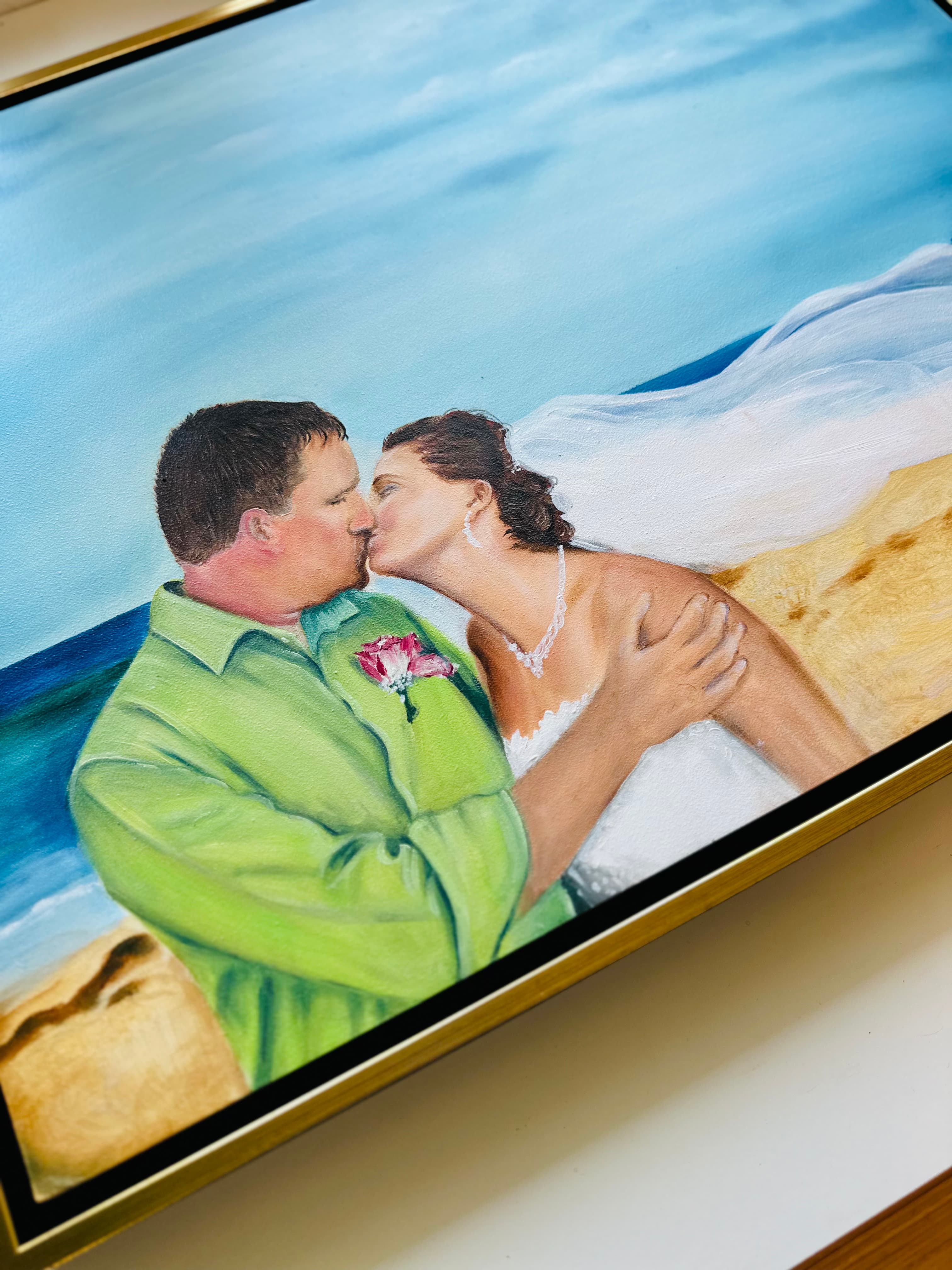 Detail of the seashore painting — the kiss, her necklace, and the rose boutonniere on his green shirt