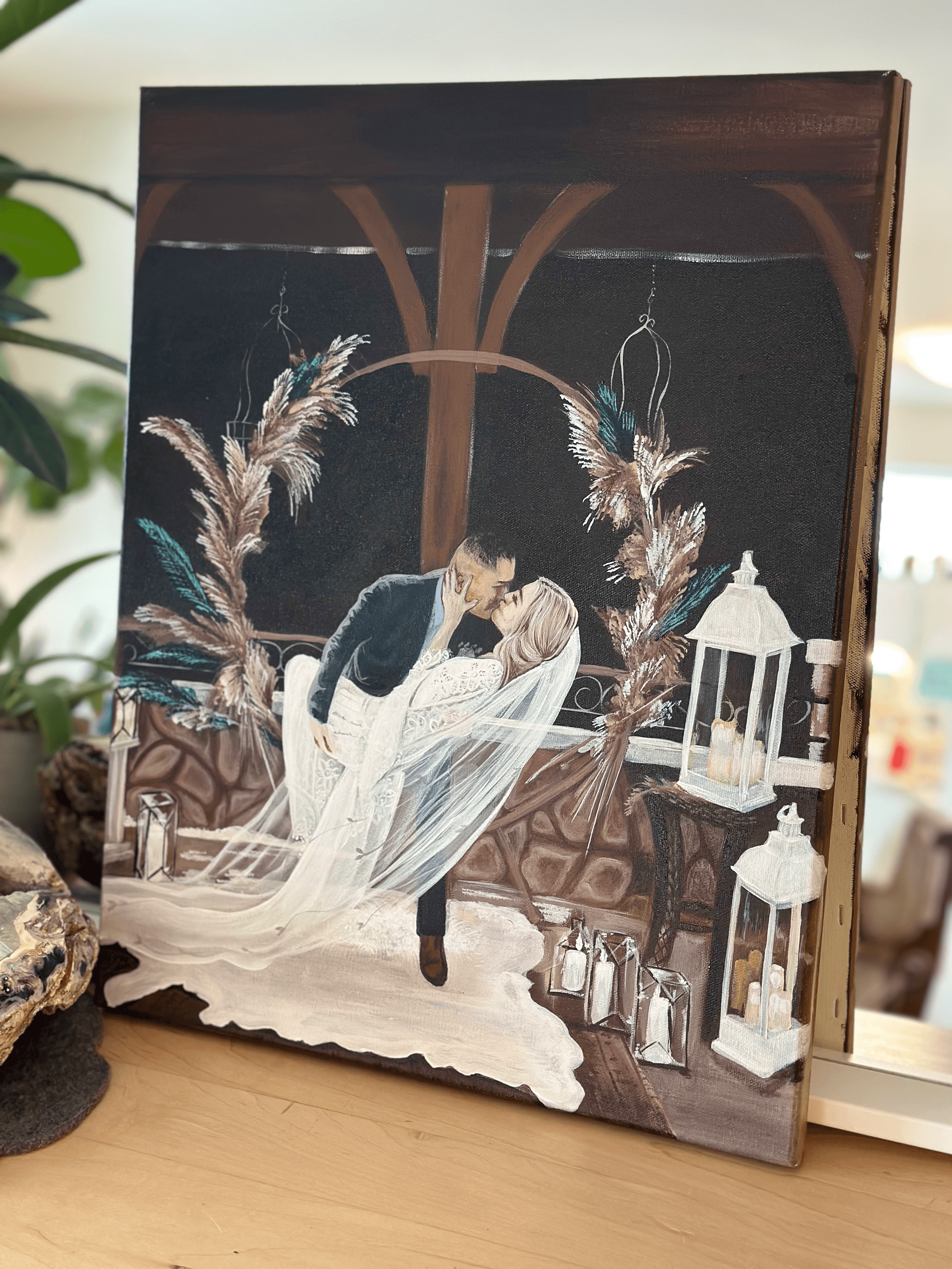 A barn wedding painting — the couple in the warm glow of lanterns