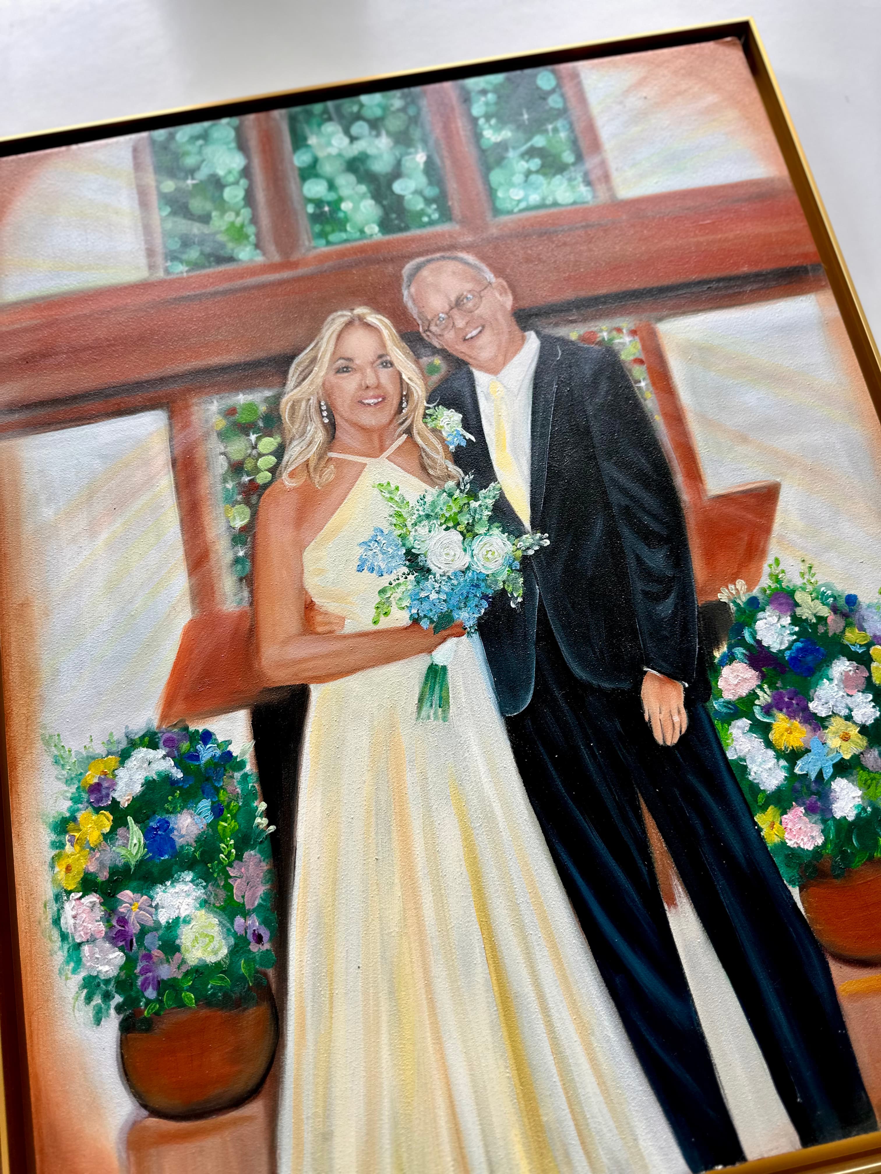 Angled view of the church wedding painting showing the gold frame and canvas texture